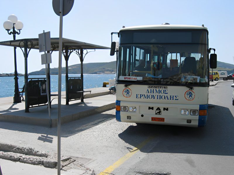 A bus is parked at the side of the road.