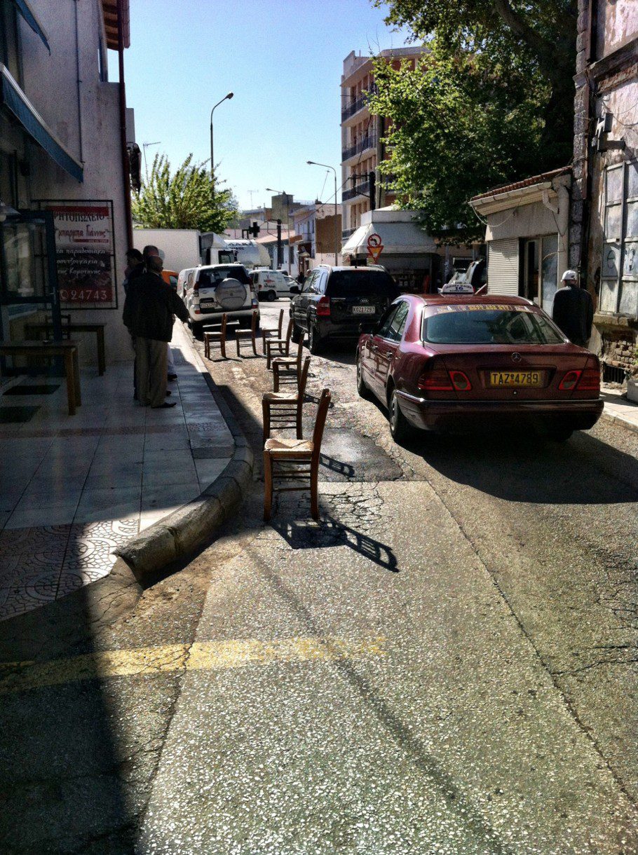 A street with cars parked on the side of it.