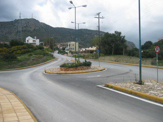 A street with many lights and trees on the side